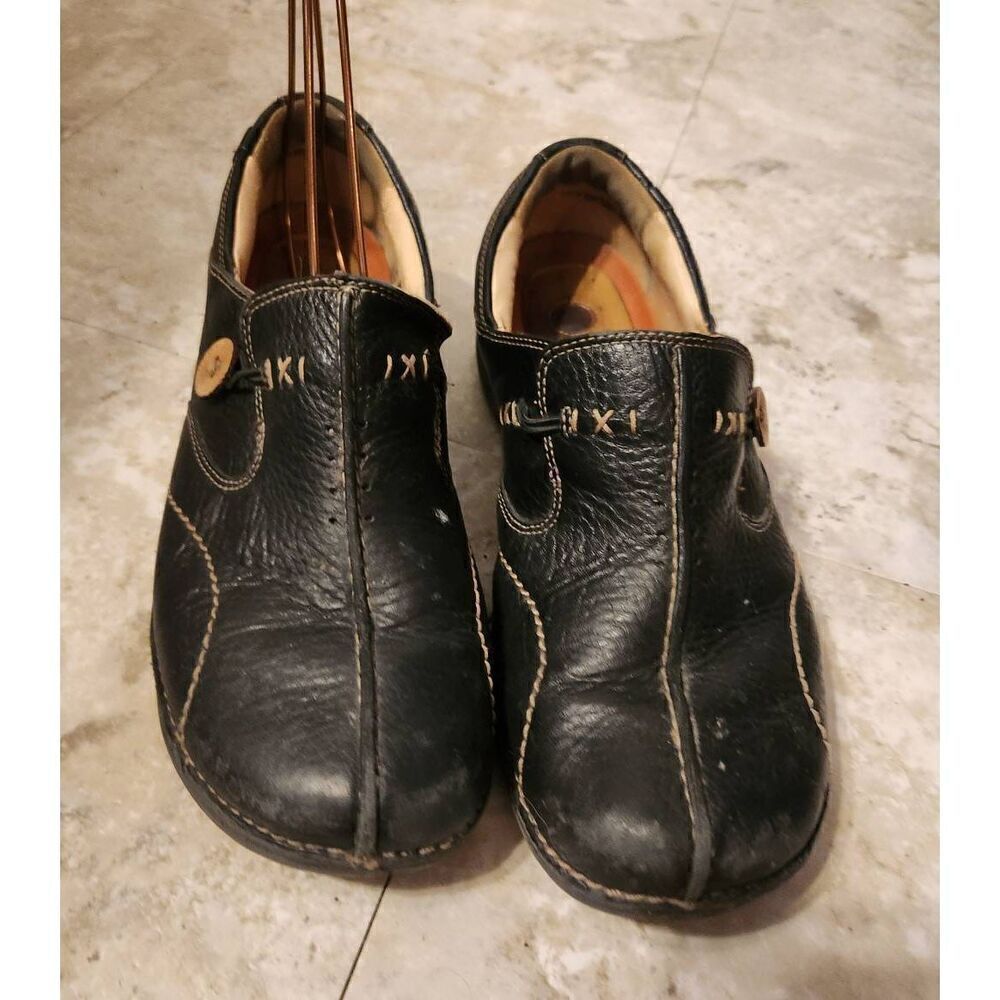 Structured Clarks black leather slip on casual shoes w/accent buttons & stitches